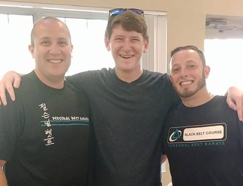 Kyle Gallagher (middle) with his teachers over the years, Joey Greenhalgh (left) and Master John Camara